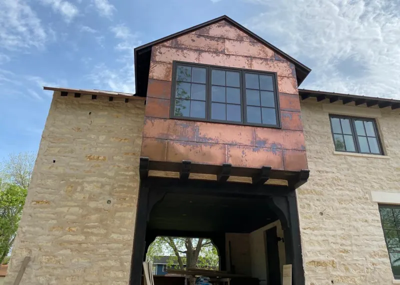 Copper metal panel facade on a stone building for Skylight Installation in Flagler Beach
