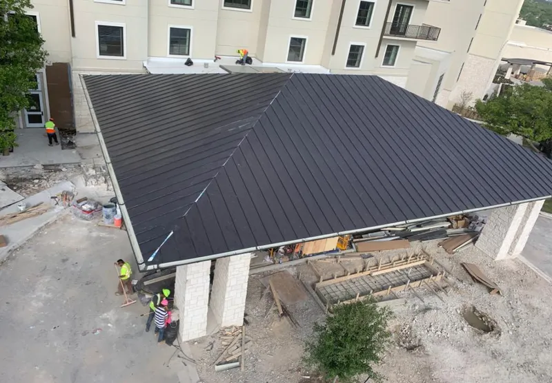 Metal roofing installation team working on a commercial building in Flagler Beach