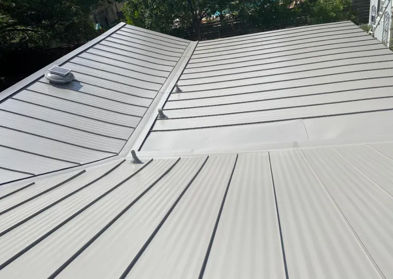 Solar attic fan installed on a metal roof for Roof Ventilation in Flagler Beach